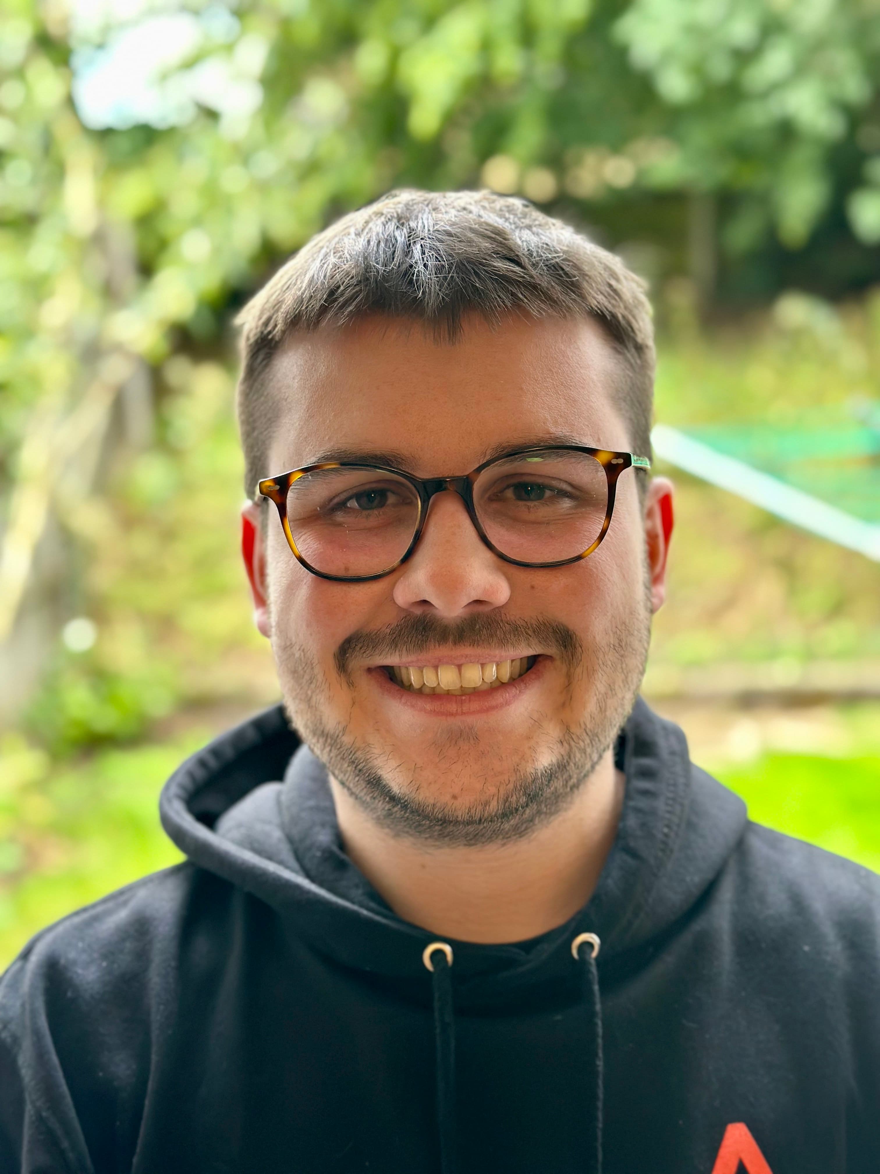 Adam smiling and looking into the camera